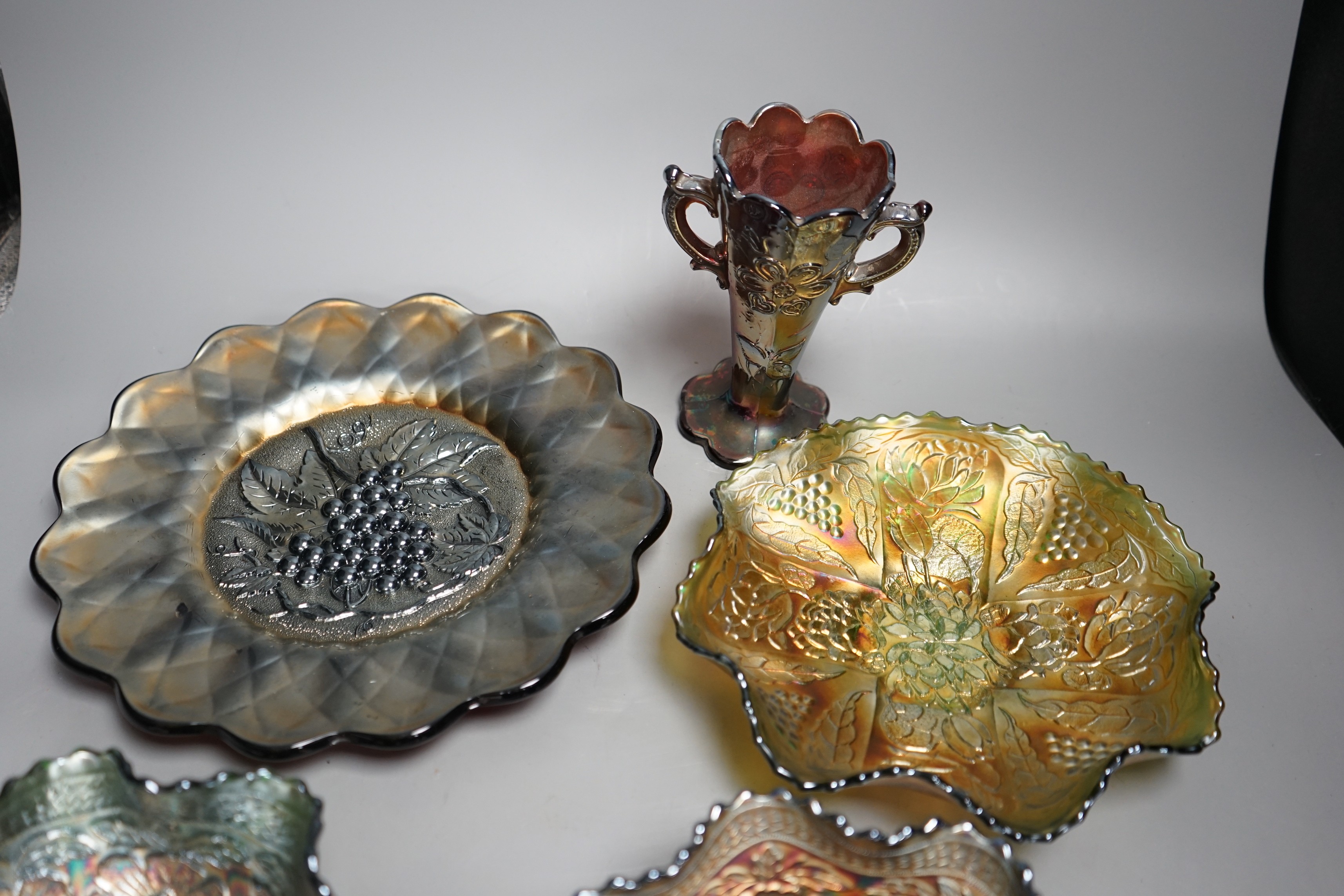 A group of four American Carnival glass dishes and a two handled vase (5), largest dish 28cms diameter